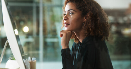 Woman, computer and thinking in office at night, accountant online and monitor economy growth....