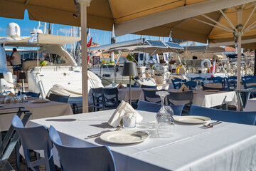 Table in a cafe with a tablecloth in Fiskardo village, Kefalonia Island, Greece.