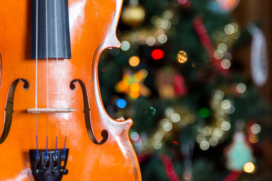 a violin wiht a christmas tree