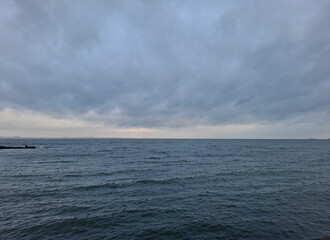low dark blue clouds over the sea