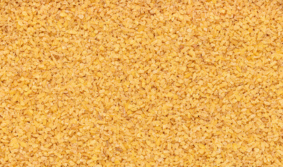 Macro photography of bulgur, cracked wheat, groats, cereal, grain, hulled barley, natural healthy vegan food, dietary fiber