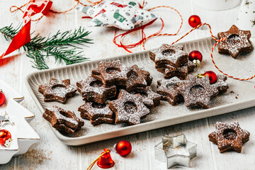 Traditional Linz Christmas cookies filled with quince jam on a white wooden background