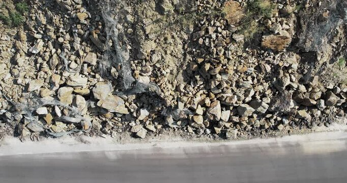Landslide, rockfall on the road in the mountains