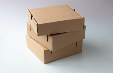 Three brown narrow cardboard boxes on a white background