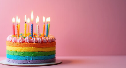 Colorful rainbow cake with candles