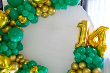 Colorful balloon arch celebrating a 14th birthday in a festive setting