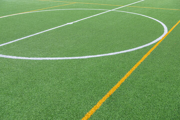 Detail of the center of an artificial grass 7-a-side football field.