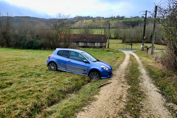 Car ending up in a drainage ditch after joy riders tried to take a short cut across a field at night
