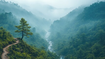 Serene mountain landscape with a winding river and misty valleys under a tranquil blue sky