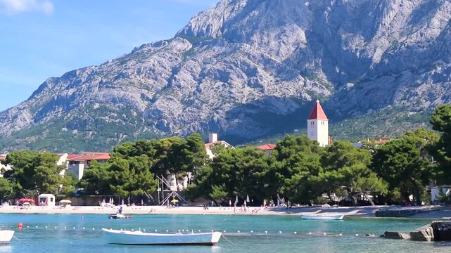 Serenely calm Adriatic Sea in summer season. Clean small-pebble beach on a sunny morning. Promajna, Croatia. Magnificent pine trees grow by Adriatic sea. Vacation location.