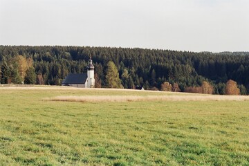 church in german Ore mountains in Czechia on 23. September 2024 on color film - blurriness and noise of scanned 35mm film were intentionally left in image