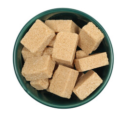 Brown cane sugar cubes in bowl isolated on white background, top view