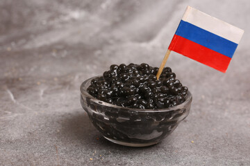bowl of black caviar with russian flag