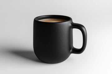 A black mug filled with coffee sits on a white background, showcasing a simple yet elegant design.