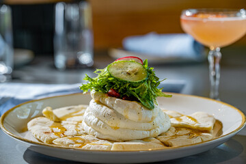 Whipped Feta on Pita, Drizzled with Honey and topped with sun dried tomatoes, arugula, radish and cucumber.
