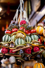 Christmas decorations colorful balls and toys, fir tree branches and cones, lanterns, small angel and Santa figures. Christmas market fair in Europe. Preparation for celebration of xmas and New Year