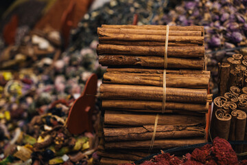 Aromatic cinnamon sticks bundled together in a spice market, showcasing the warm tones and textures of this popular spice