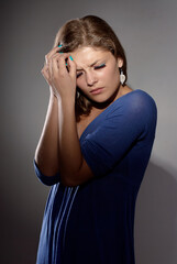 Young Woman Experiencing Stress and Headache in Isolated Studio Setting