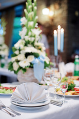 Elegant Table Setting With Floral Centerpiece and Candles for a Formal Event