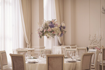 Beautiful blossoming flowers (roses, hydrangeas, carnations, eustoma) in blue, antique blue and peach colours at wedding.