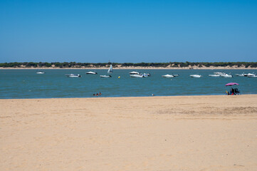 Golden sandy beaches and promenade of Qudalquivir river in Sanlucar de Barrameda, Andalusian town, Spain in summer