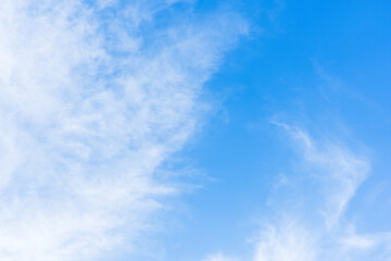 wispy white clouds in blue sky