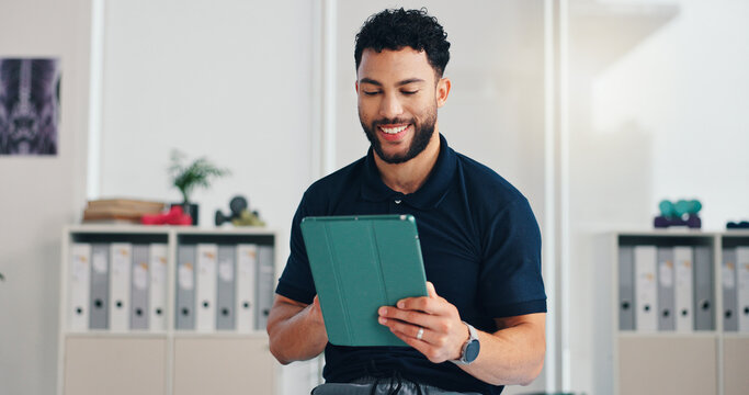 Man, physiotherapist and tablet in office with smile, registration and healthcare service. Chiropractor, happy and tech in private practice for reflexology, patient schedule and physiotherapy startup - Powered by Adobe