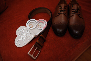 Elegant Wedding Accessories Arrangement Featuring Shoes, Belt, and Rings