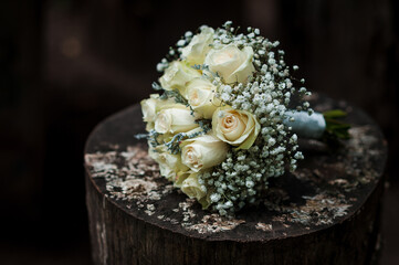 Elegant White Rose Bouquet with Baby's Breath on Rustic Wood