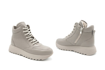 Fashionable leather lace-up boots with fur lining isolated on white background. View from all sides. Insulated sneakers.