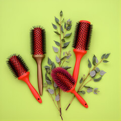 Contemporary hairbrushes and foliage arranged in a flat lay composition on a vibrant green backdrop.