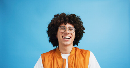 Studio, laugh and man with glasses for vision, wellness and satisfied with prescription for eye...