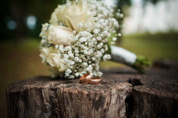 Romantic Wedding Setting with Gold Rings and Elegant Bouquet