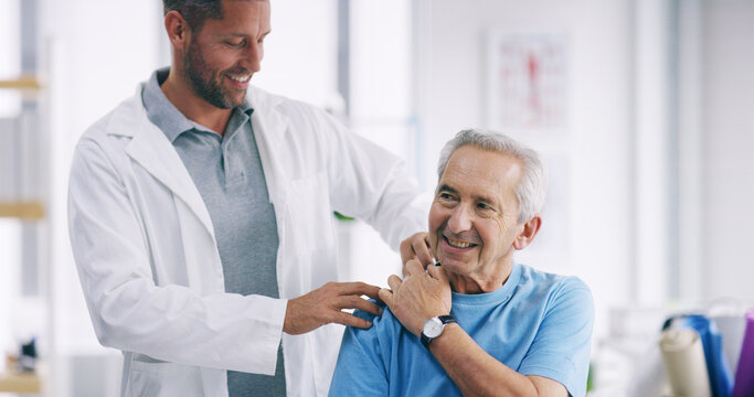 Doctor, elderly patient and shoulder pain with injury for checkup, exam or physiotherapy at hospital. Male person, medical worker and senior client with physiotherapist for muscle tension or relief