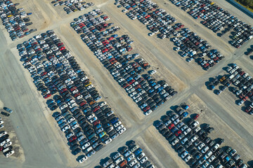 Used damaged cars on auction reseller company big parking lot ready for resale services. Sales of secondhand vehicles for rebuilt or salvage title