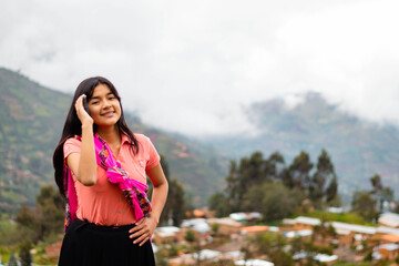 Mujer campesina atractiva en América Latina, feliz mientras usa un teléfono inteligente mirada a...