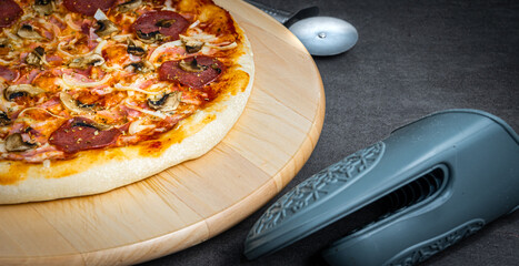 A composition of pizza and kitchen accessories