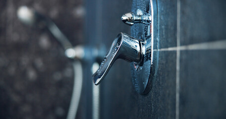 Shower, handle and faucet closeup in bathroom for hygiene, grooming and morning routine. Cleaning, interior and empty room with metal water lever at home for plumbing, washing and house decor