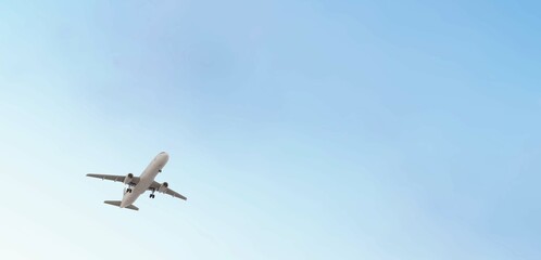 Airplane flies in blue sky. Travel, tourism. Airplane takes off against the background of blue sky....