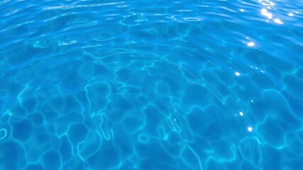 Obraz premium Crystal clear water ripples reflecting sunlight creating a mesmerizing pattern on the surface of a calm lake, close-up, calm