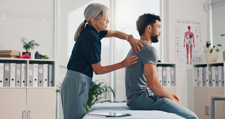 Chiropractor, back massage and physiotherapy on patient at consultation for spine problem or...
