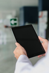 Close-up of a doctor working on a tablet in a medical setting
