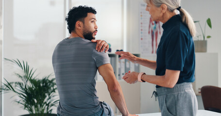 Physical therapy, shoulder pain and patient man at consultation for problem or inflammation....