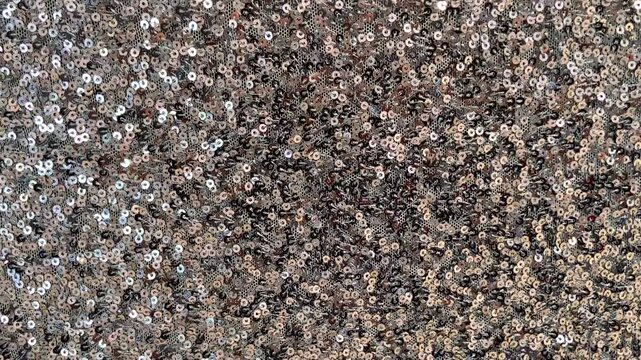 Silver sequin fabric with shimmering highlights luxurious textured background for design.Holiday abstract glitter texture with blinking lights,4K video