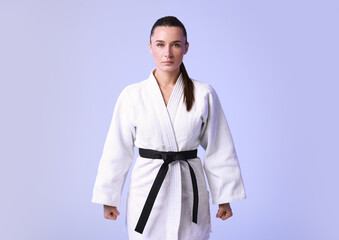 Fototapeta premium Karate fighter in kimono on light background