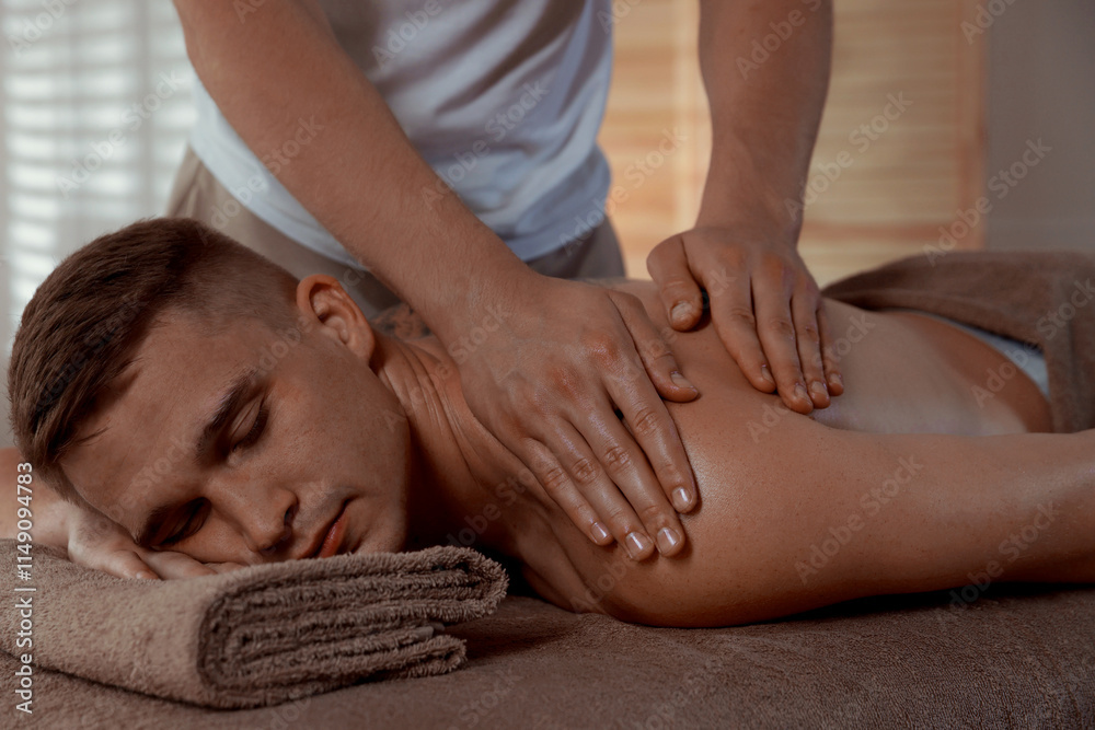 Wall mural Massage therapist working with patient in clinic, closeup