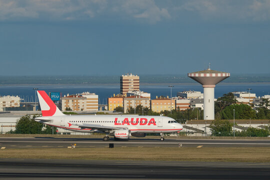 Lisbon, Portugal - September 11, 2023: Lauda Europe Airbus A320-214 passenger plane taxi on runway in Humberto Delgado Airport in Lisbon