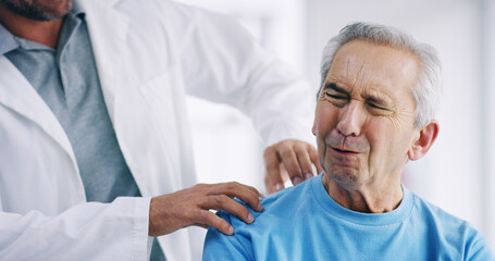 Doctor, elderly patient or shoulder pain with physiotherapist for checkup, exam or visit at...