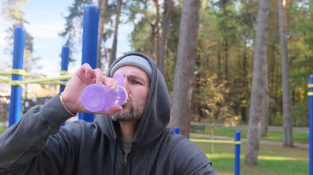 Athlete rests and hydrates with water after training