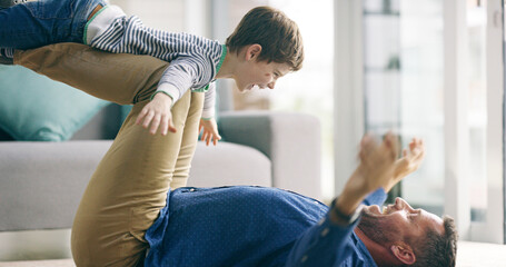 Dad, boy and airplane on floor in home, game and playful with smile, knees and bonding with love in lounge. Father, child and lifting for plane, flight or excited with laugh on carpet in family house
